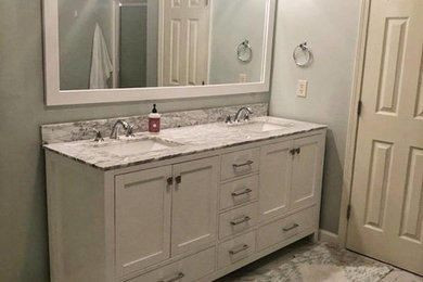 Example of a mid-sized transitional master marble floor and gray floor bathroom design in Birmingham with shaker cabinets, white cabinets, gray walls, an undermount sink, granite countertops and gray countertops
