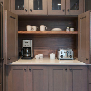 Mid-sized transitional u-shaped kitchen pantry in Burlington with shaker cabinets, grey cabinets, quartz benchtops, brown splashback and stainless steel appliances.