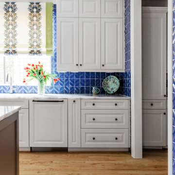 Refined Kitchen Remodel in Houston, TX with Blue Backsplash & White Cabinetry