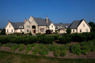 Inspiration for a huge craftsman three-story stone exterior home remodel in Other with a gray roof