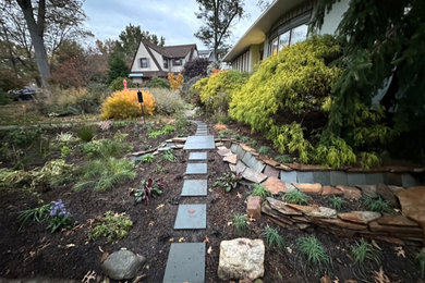 Photo of a contemporary full sun front yard stone landscaping in Philadelphia.