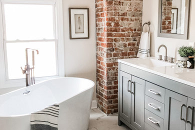 Example of a large urban master cement tile floor, gray floor and double-sink bathroom design in Columbus with shaker cabinets, white cabinets, a drop-in sink, marble countertops, white countertops and a built-in vanity