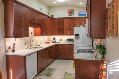 Inspiration for a mid-sized contemporary u-shaped kitchen remodel in Tampa with shaker cabinets, quartz countertops and stone tile backsplash