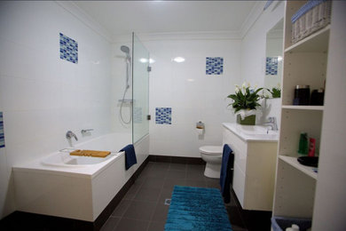 Inspiration for a large transitional bathroom in Sydney with raised-panel cabinets.