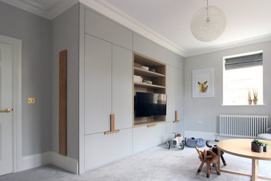 Photo of a large contemporary gender neutral nursery in Cheshire with grey walls, carpet and grey floors.
