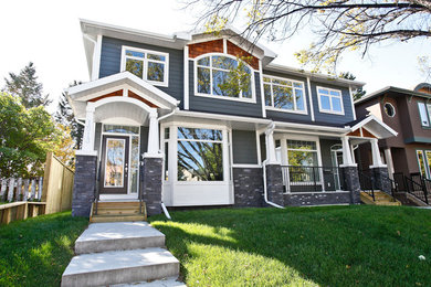 Mid-sized transitional gray two-story wood gable roof photo in Calgary