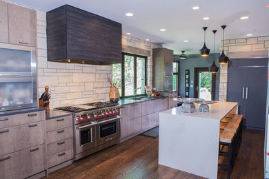 Open concept kitchen - large modern u-shaped medium tone wood floor and brown floor open concept kitchen idea in Wichita with an island, an undermount sink, flat-panel cabinets, dark wood cabinets, marble countertops and stainless steel appliances