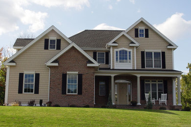 Large traditional beige three-story mixed siding exterior home idea in Bridgeport with a shingle roof