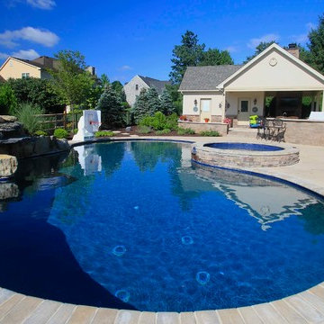 Custom Freeform style salt water in ground pool with Pool House and Raised Spa