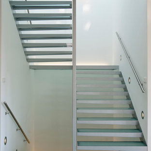 Expansive contemporary glass straight staircase in Other with open risers.