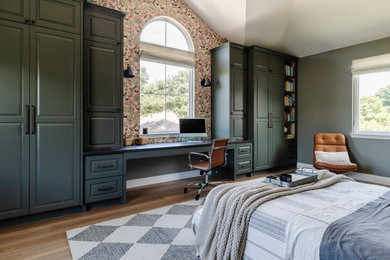 Example of a large transitional guest vinyl floor, brown floor, vaulted ceiling and wallpaper bedroom design in Dallas with green walls