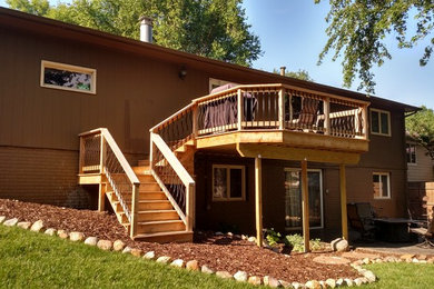 Example of a mid-sized classic backyard deck design in Other with no cover