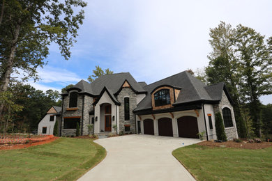 Example of a huge minimalist gray three-story mixed siding exterior home design in Charlotte with a gray roof