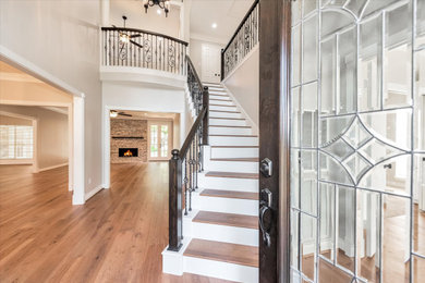 This is an example of a classic entrance in Houston with brown floors.