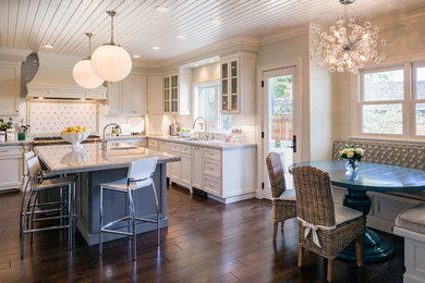 Design ideas for a traditional u-shaped open plan kitchen in San Francisco with a double-bowl sink, beaded inset cabinets, white cabinets, marble benchtops, white splashback, ceramic splashback, panelled appliances, with island and dark hardwood floors.