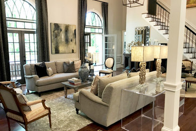 Example of a mid-sized transitional formal and open concept dark wood floor and brown floor living room design in Atlanta with beige walls, a standard fireplace, a brick fireplace and no tv