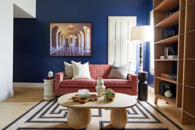 Inspiration for a mid-sized contemporary enclosed light wood floor and beige floor living room library remodel in San Francisco with blue walls and no tv