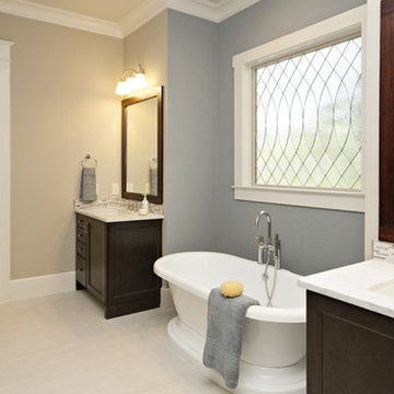 Traditional bathroom with dark wood cabinets and free standing bath tub