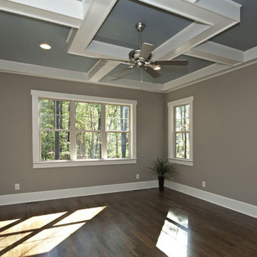 Traditional bedroom with tray ceiling and wood floor
