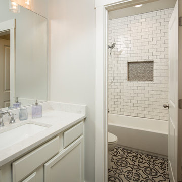 Guest Bath with Patterned Tile Floor and Subway Tile Tub Surround