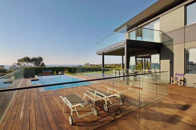 Design ideas for a large modern backyard deck in Melbourne with no cover.