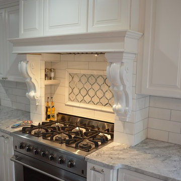 Traditional Spacious White Kitchen with Custom Island and Booth