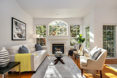 Example of a mid-sized trendy formal and open concept light wood floor living room design in Seattle with white walls and no tv