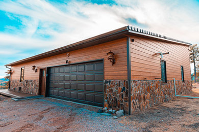 Example of a classic brown two-story concrete fiberboard house exterior design in Other with a shingle roof and a gray roof