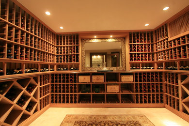 Inspiration for a mid-sized traditional wine cellar in New York with storage racks, beige floor and travertine floors.