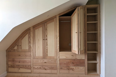 This is an example of a classic built-in wardrobe in Other with shaker cabinets and light wood cabinets.