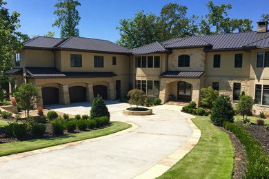 Large traditional beige two-story mixed siding exterior home idea in Other with a shingle roof