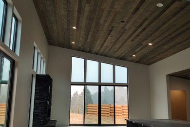 Inspiration for a contemporary open concept concrete floor, gray floor and wood ceiling living room remodel in Seattle with white walls