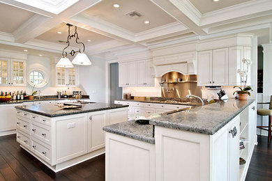 Eat-in kitchen - large transitional l-shaped dark wood floor and brown floor eat-in kitchen idea in Tampa with raised-panel cabinets, white cabinets, marble countertops, white backsplash, an island, an undermount sink, metal backsplash and stainless steel appliances