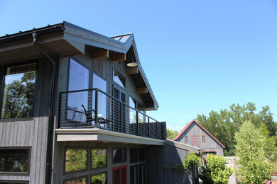 Inspiration for a small modern rooftop second story cable railing deck remodel in New York with a roof extension