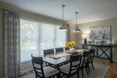 Transitional brown floor dining room photo in Grand Rapids with beige walls
