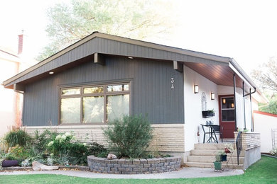 Small trendy multicolored one-story mixed siding exterior home photo in Other