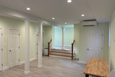 Example of a large transitional porcelain tile and gray floor basement design in New York with beige walls