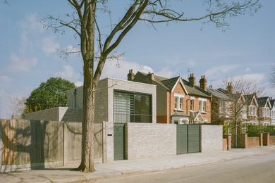 This is an example of a modern split-level brick house exterior in London.