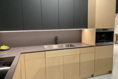 Kitchen - mid-sized contemporary kitchen idea in Seattle with an undermount sink, flat-panel cabinets, black cabinets and black countertops