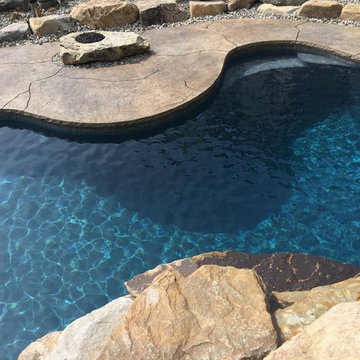 Spring Brook Township custom pool with boulders and waterfall