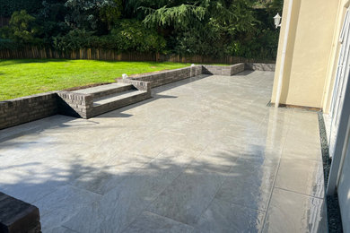 Mid-sized trendy backyard tile patio photo in Surrey