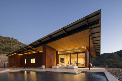 Inspiration for a modern one-story house exterior remodel in Phoenix with a metal roof