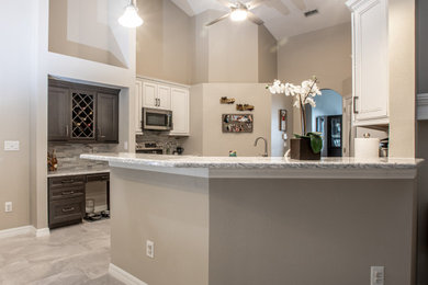 Inspiration for a mid-sized transitional u-shaped porcelain tile and gray floor kitchen pantry remodel in Orlando with an undermount sink, recessed-panel cabinets, white cabinets, quartz countertops, multicolored backsplash, mosaic tile backsplash, an island and gray countertops