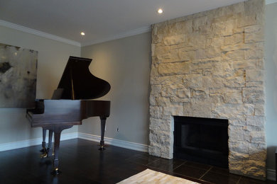 Living room - mid-sized contemporary enclosed dark wood floor living room idea in Toronto with a music area, gray walls, a standard fireplace and a stone fireplace