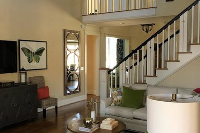 Living room - mid-sized transitional open concept medium tone wood floor living room idea in Other with beige walls, no fireplace and a wall-mounted tv