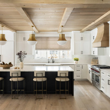 Luxurious Kitchen with White Cabinets and Gold Pendant Lights