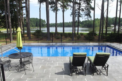 Backyard concrete paver and rectangular lap pool photo in Richmond