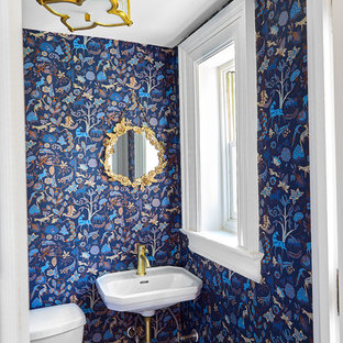 Small transitional 3/4 marble floor and yellow floor bathroom photo in Wilmington with a one-piece toilet, blue walls, a wall-mount sink and white countertops