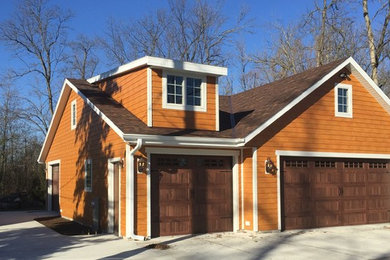 Large arts and crafts detached four-car garage photo in Milwaukee