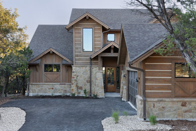 Example of a brown two-story wood and board and batten exterior home design in Austin with a shingle roof and a brown roof